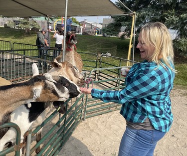 Melanie Engel of Elmwood feeds the goats at the Lucknow Fall Fair on Sept. 17. Photo by Kelly Kenny/Lucknow Sentinel.