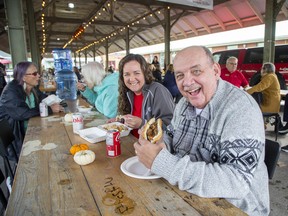Mark Schleihauf and his daughter Richelle Hogarth have a a bite to eat as the United Way Elgin-Middlesex launches its fall fundraising campaign with its Harvest Lunch, at  Horton Farmers' Market in St. Thomas. Derek Ruttan/Postmedia