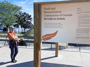 Deborah Hudson reads the 94 Calls to Action on the National Day for Truth and Reconciliation at Confederation Park on Friday.