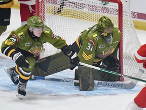 Goaltender Dom DiVincentiis of the visiting North Bay Battalion parries a scoring attempt by the Soo Greyhounds in the teams' Ontario Hockey League season opener Friday night.
