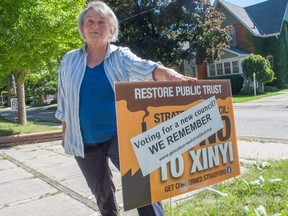 Get Concerned Stratford member Sharon Collingwood next to one of the group’s election-style signs, which remind residents about a controversial glass plant development they opposed last year. The city’s clerk claims the signs violate election rules around third party advertising and must be taken down, but the group insists they haven’t done anything wrong. Chris MontaniniStratford Beacon Herald