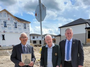 Two streets in the new Buckingham Estates housing development west of Main Street in Exeter have been named after local Second World War heroes Murray Greene and Edward Triebner, the latter who was killed in Belgium in 1944. Pictured from left at the intersection of Triebner and Greene streets are Triebner's brother Tom (holdinng a photo of his later brother), Greene, and South Huron Mayor George Finch. Handout