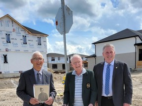 Two streets in the new Buckingham Estates housing development west of Main Street in Exeter have been named after local Second World War heroes Murray Greene and Edward Triebner, the latter who was killed in Belgium in 1944. Pictured from left at the intersection of Triebner and Greene streets are Triebner's brother Tom (holding a photo of his late brother), Greene, and South Huron Mayor George Finch. Handout