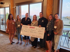 The Kalix Foundation recieves an honourary big cheque for $4,900--the amount that the 100 Airdrie Women Who Care donated to them after their previous meeting. The group donated $6,000 to Airdrie Pride Society on September 27.