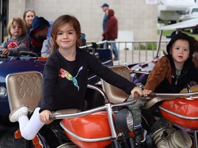 Brynlee LeGrand, 4, takes a ride with her brother Nixon, 2, at the Ripley Fall Fair midway on Sept. 24. Photo by Kelly Kenny/Kincardine News.