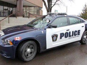 A Sarnia police cruiser is parked in front of the police station.