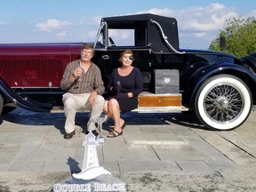 The 2022 Cobble Beach Concours d'Elegance Best in Show winner, a 1928 Isotta Fraschini A SS, which also won the top honours at the inaugural Cobble show in 2013. Dave and Charlotte Delcamp, who brought the car for owner Peter Boyle, enjoy some champagne, while the winning trophy sat in front of them, on Sunday, Sept. 18, 2022 in Georgian Bluffs, Ont. (Scott Dunn/The Sun Times/Postmedia Network)