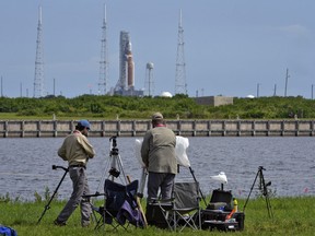 Photographers pack up their equipment as NASA's new moon rocket sits on Launch Pad 39-B after being scrubbed at the Kennedy Space Center,&ampnbsp;in Cape Canaveral, Fla.,&ampnbsp;Saturday, Sept. 3, 2022. Canadian astronaut David Saint-Jacques says the scrubbing of the Artemis moon rocket launch today is disappointing, but necessary. THE CANADIAN PRESS/AP-Chris O'Meara