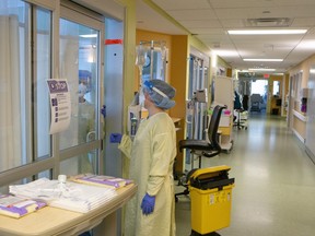 Nurses tend to a COVID-19 patient in the Intensive Care Unit at the Bluewater Health Hospital in Sarnia, Ont., on Tuesday, January 25, 2022. Nearly two and a half years since the onset of the COVID-19 pandemic, what started as a challenge related to high infection rates overloading hospitals has evolved into an acute labour challenge.THE CANADIAN PRESS/Chris Young