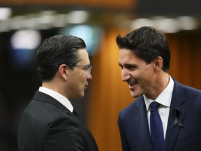 Prime Minister Justin Trudeau and Conservative leader Pierre Poilievre greet each other as they gather in the House of Commons on Parliament Hill to pay tribute to Queen Elizabeth in Ottawa on Thursday, Sept. 15, 2022. A new poll suggests Trudeau enjoys a slight lead over Poilievre when it comes to which leader Canadians feel would make the best prime minister. THE CANADIAN PRESS/Sean Kilpatrick
