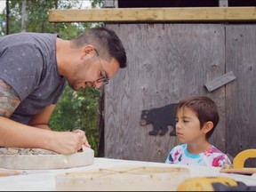 Brant Janvier shows his son August how to build a drum in Heartbeat of a Nation, a documentary produced for the National Film Board of Canada by Eric Janvier.