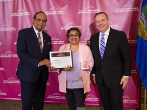 Lana Santana accepts an award from Premier Jason Kenney and Associate Minister Muhammad Yaseen for outstanding community contributions. Photo supplied.