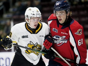 Sarnia Sting's Owen MacDonald (6) battles Windsor Spitfires' Colton Smith (61) in front of the Sting's net in the second period at Progressive Auto Sales Arena in Sarnia, Ont., on Saturday, Sept. 24, 2022. Mark Malone/Chatham Daily News/Postmedia Network