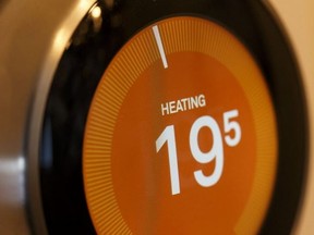 A smart thermostat enters a heating cycle in a home in Edmonton, Alberta on Saturday, Dec. 30, 2017