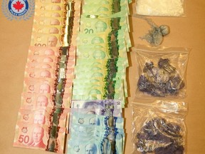 Cash and drugs displayed from a major drug seizure following an investigation involving Owen Sound, West Grey and Saugeen Shores Police, which concluded Sept. 28, 2022. (Owen Sound Police Service photo)