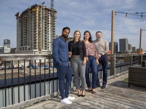 Trackunit employees Jaramie Lawrence, left, Emily Moroz, Daniela Lazarevic and Brent Horne are on the roof of the technology company's new location in downtown London on Tuesday, Sept. 20, 2022. The Danish-based software manufacturer is bringing 80 workers downtown. (Derek Ruttan/The London Free Press)