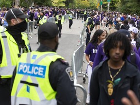 London police barricaded portions of the middle of the street when thousands of students gathered on Broughdale Avenue during Western University's Homecoming celebrations in London on Saturday September 24, 2022. The area was kept free of people to ensure emergency service access. Derek Ruttan/The London Free Press