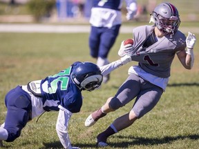 Laurier's Lucan Clewlow can't hold on to South running back Noah Amaral in a Thames Valley Central senior boys game Friday, Sept. 23, 2022, at Laurier. The Rams won the season opener for both teams 27-14. (Mike Hensen/The London Free Press)