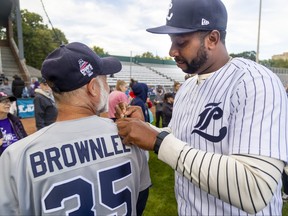 Longtime London Majors star Cleveland Brownlee signs the jersey of Dan Klaver, a season ticket holder, as the team welcomed fans to a celebration of their league championship at Labatt Park in London on Friday September 23, 2022. Mike Hensen/The London Free Press/Postmedia Network