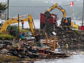 Crews work on cleaning up in the aftermath of Hurricane Fiona in Burnt Islands, Newfoundland, Canada September 27, 2022. REUTERS/John Morris