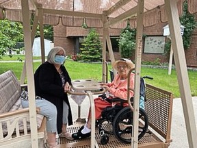 Yolanda Gregory (right) and her daughter, Gloria Torrance (left), using the new wheelchair accessible swing at the Crowsnest Pass Health Centre.