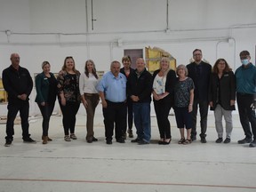 City of Airdrie council, staff, and APL Board members stand infront of their progress made in the first minutes of demolition commencing of the old fire hall on Main Street.