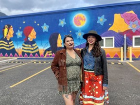 Artists, Kayla Bellerose (bb iskwew) and Cheyenne Bearspaw (Chey Ozinja-Thiha), after completing Canmore's newest mural. The piece will be the first addition to Canmore's public art collection created by Indigenous artists. The mural is inspired by the Three Sisters mountains in the Canmore area, and it highlights the resilience and power of Indigenous women from the Stoney Nakoda Nation. Photo Marie Conboy/ Postmedia.
