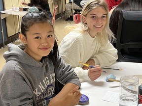 Students Natalia Bell (left) and Brooke Dutrisac design positivity rocks during the first Wellness Wednesday at Barrydowne College. 
Supplied