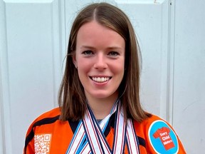 Victoria Bach dons an Orange Jersey Project hockey jersey, an initiative she is involved with, while showing off her medals, the latest of which is a gold medal earned with Team Canada at the International Ice Hockey Federation women's world championship tournament in Denmark. (Photo courtesy of Victoria Bach)