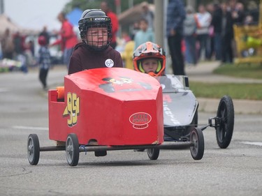 Mason Barker (left) wins his heat race Monday during the Brantford and District Labour Council's annual soap box derby in Brantford. CHRIS ABBOTT