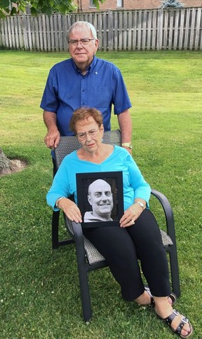 Jack and Carolyn Scott hold a photo of their son, Jeff Scott, who was killed when hit by a vehicle in Waterford almost two years ago.  The family said a glitch in the justice system left them uninformed about the ongoing court case and shocked when the charge against the driver were dropped.  Submitted