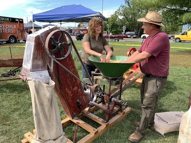 At the Six Nations Fall Fair on the weekend, Jake and Erica Tapp of Lowbanks, members of the Walpole Antique Farm Machinery Association, show off a 1915 grinder made by Verity Plow Works in Brantford that would chop up hard corn for chicken feed. Susan Gamble