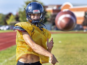Assumption College quarterback Tyson Kemp kicks the ball during team practice. Brian Thompson