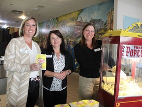 Beth Sanders (left), Laurier Brantford's campus experience co-ordinator; Maggie Bailey-Bomberry, the university's co-ordinator of administration and special projects, and Julie Perkins, co-ordinator of Laurier LaunchPad Brantford, serve popcorn on Thursday in the former movie theatres at One Market. The university has plans to turn the space into a community cultural hub. Michelle Ruby