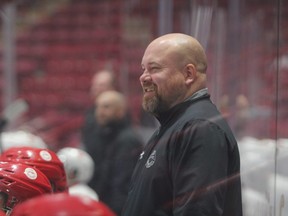 Brent Hughes (shown here) behind the bench of Team Red during an intrasquad game at Hounds training camp in early September. The Hounds signed Hughes after former assistant coach Jamie Tardif departed for the Hartford Wolf Pack of the American Hockey League.