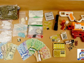 Brockville police released this image of drugs, weapons and cash seized in two raids on Thursday. (SUBMITTED PHOTO)