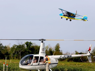 A plane takes off from the Brockville-1000 Islands Regional Tackaberry Airport while a Brockville Flying Club volunteer assists Kouri's Kopters Sunday morning, during the club's Fly-In Breakfast. (RONALD ZAJAC/The Recorder and Times)