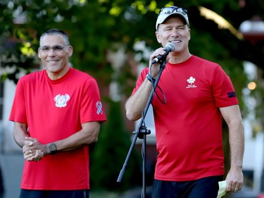 Rob Shearer, right, co-chairman of the National Peace Officers' Memorial Run, speaks to participants on the Court House Green while co-chairman Bob Hackenbrook listens. Both are members of the Peel Regional Police. (RONALD ZAJAC/The Recorder and Times)