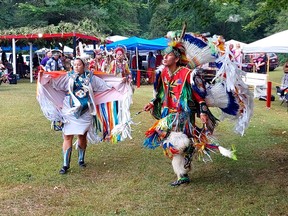 Miranda Cryle-Huff, left, and D.J. White served as head dancers during the Delaware Nation of the Thames 50th Powwow held on the weekend. They are seen here leading the Grand Entry on Sunday. PHOTO Ellwood Shreve/Chatham Daily News