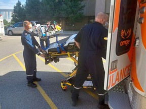 Matt Laverty, left, an advanced care flight paramedic, and Andrew Whittemore, a critical care paramedic, are seen here transferring a patient to hospital in London to be treated for a heart condition. They are part of the team that works out of the now permanent critical care land ambulance base in Chatham-Kent. PHOTO Ellwood Shreve/Chatham Daily News