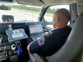 Ornge critical care paramedic Andrew Whittemore reviews a patient's details before the person is taken to a hospital in Windsor. PHOTO Ellwood Shreve/Chatham Daily News