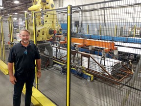 Automation has been a key factor to enabling Dajcor Aluminum Ltd. to double in size over the last two years during the COVID-19 pandemic. President Mike Kilby is seen here beside a robotic loader on Saturday during the first open house held at the Chatham plant since 2019. PHOTO Ellwood Shreve/Chatham Daily News
