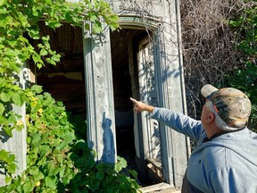 Peter Anderson points to where heart and diamond-shaped woodwork once adorned the Guyitt House, purchased by his grandparents Roy and Ethel Guyitt in 1908. (Ellwood Shreve/Postmedia Network)