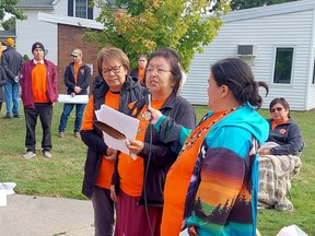 Residential school survivor Beverly Williams, middle, speaks to those attending the Healing Walk and Gathering held in Wallaceburg Thursday. She is seen her with Walpole Island councillor Elaine Wrightman, left, and Leela Thomas with the Walpole Island Employment and Training Centre. (Ellwood Shreve/Chatham Daily News)