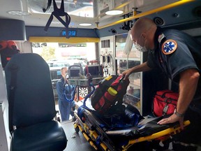 Matt Laverty, back, an advanced care flight paramedic, and Andrew Whittemore, a critical care paramedic, are seen here preparing to pick up a patient in Windsor to be transferring to hospital in London to receive a higher level of treatment for a heart condition.  They are part of the team that works out of the now permanent critical care land ambulance base in Chatham-Kent.  PHOTO Ellwood Shreve/Chatham Daily News