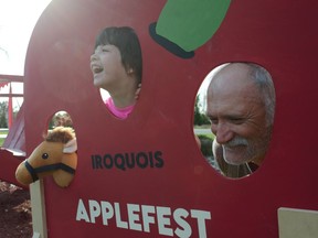From left, Zoey Yandeau and her grandfather Tim and a pony mascot enjoy the cutout display during the Iroquois Apple Festival on Saturday September 17, 2022 in Cornwall, Ont. Greg Peerenboom/Special to the Cornwall Standard-Freeholder/Postmedia Network