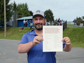 Following a meeting with 2022 council candidates, Cornwall Minor Baseball president Kyle Bergeron shows the pledge form available for candidates. Pictured on Saturday September 17, 2022 in Cornwall, Ont. Greg Peerenboom/Special to the Cornwall Standard-Freeholder/Postmedia Network