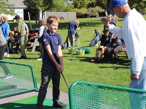 Grade 6 student Lucas Inderbitzin gets some guidance from mentor Fred Langlotz at the driving range during a Stay on Course 4 Communities session Thursday afternoon. Photo on Sept. 29, 2022, in Cornwall, Ont. Todd Hambleton/Cornwall Standard-Freeholder/Postmedia Network