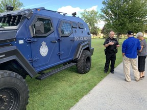 Cornwall Police Service Staff Sgt. George Knezevic speaks with passersby that stopped to see the service's new Zodiac Engineering Armoured Rescue Vehicle parked outside Lamoureux Park on Thursday September 1, 2022 in Cornwall, Ont. Hugo Rodrigues/Cornwall Standard-Freeholder/Postmedia Network