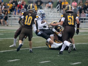 Superior Heights quarterback Gabe Barkley gets swallowed up by the Colts defence during first half action on Saturday morning at Superior Heights. The Colts opened the high school football season with a 43-6 win over the 'Hawks.